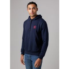A man in a navy hoodie with a red logo stands confidently against a neutral background. He is also wearing blue jeans, with a calm expression.