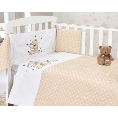 Baby crib with beige polka dot bedding, teddy bear, and embroidered bear designs on pillows and blanket.