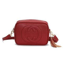 A black textured leather crossbody bag with a rounded rectangular shape. It features a prominent interlocking logo and a detachable strap with gold hardware.