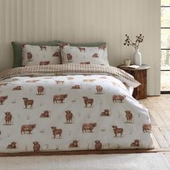 Catherine Lansfield Angus Highland Cow reversible duvet cover set with gingham reverse