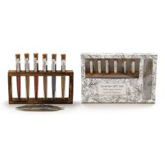 Incense gift set with six fragrance tubes in a wooden stand, labeled with Rose, Jasmine, Patchouli, Amber, Lavender, and Vanilla. Includes decorative feather holder.