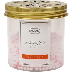 Clear container filled with small white and pink beads labeled "Addis Dehumidifier with Scent - Grapefruit," featuring a golden, vented lid.