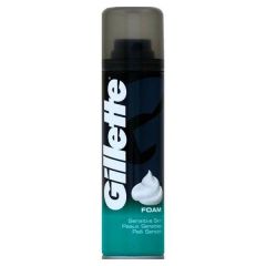 Tall black and teal can of Gillette shaving foam for sensitive skin, featuring bold white branding and a gray, translucent cap. Clean and modern design.
