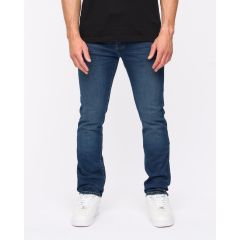 A person wearing dark blue jeans and a black shirt, standing against a plain white background. White sneakers complete the casual look.