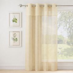 Full length Andorra cream sheer curtain hanging at window allowing natural light through