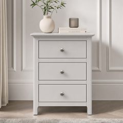 Appleby grey 3 drawer bedside locker with silver handles in a modern bedroom setting.