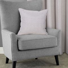 Showing the Arlo Beige Cushion Cover on a chair