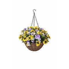Artificial hanging basket with yellow purple and white pansy flowers in wicker basket on white background