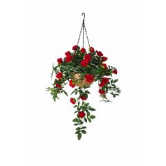 Artificial hanging basket with red rose flowers and trailing greenery in wicker basket on white background