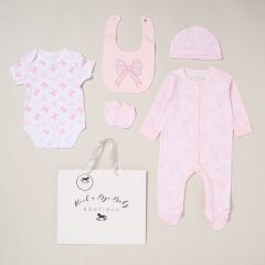 Baby girls pink bow 5 piece gift set with sleepsuit, bodysuit, bib, hat and mittens on neutral background