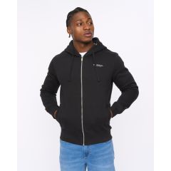 Young man in a black zip-up hoodie with hands in pockets, looking to the left. He wears blue jeans against a white background, exuding a casual vibe.