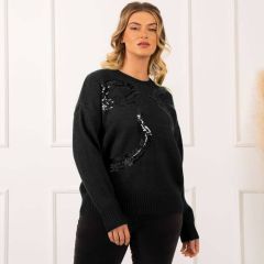 Model wearing Women’s black jumper with large sequin bow detail on the front.