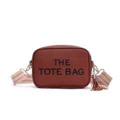 Brown rectangular tote bag with black text "THE TOTE BAG" on the front. Features a brown-and-white patterned strap and a brown tassel accent.