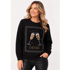 A woman wearing a black knitted holiday jumper featuring a sequin champagne glass graphic and an embroidered "CHEERS!