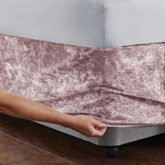 Corner detail of the Catherine Lansfield crushed velvet divan base wrap in blush pink, showing luxurious soft texture and fitted design