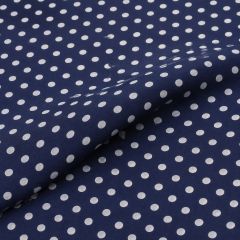 Close-up of navy georgette fabric covered in evenly spaced white polka dots.