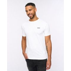 A man wearing a white t-shirt and black jeans, smiling with a relaxed posture against a plain white background. Casual fashion, confident mood.