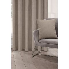 A gray modern chair with a Biscuit coloured cushion is set on light wood flooring. Beside it, beige curtains hang, creating a calm, minimalist ambiance.