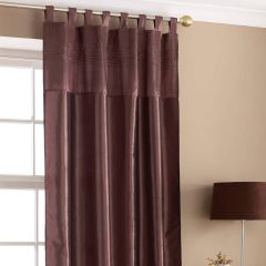 Chocolate taffeta tab-top curtain panel hanging beside window