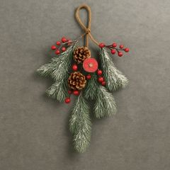 Christmas hanging greenery spray with pinecones, red berries, and twine loop, lightly frosted with artificial snow