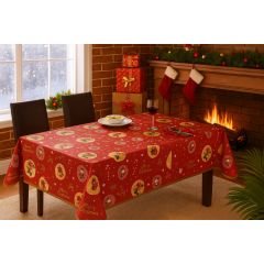 Red Christmas tablecloth with festive motifs displayed on a rectangular dining table in a holiday-decorated living room.
