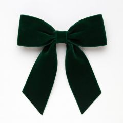 Dark green velvet Christmas bow with long tails on a white background