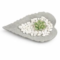 Grey leaf-shaped decorative dish with white pebbles