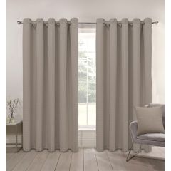 Biscuit curtains hang on a rod in front of a large window, letting in soft light. A gray chair with a matching pillow sits to the right, creating a calm atmosphere.
