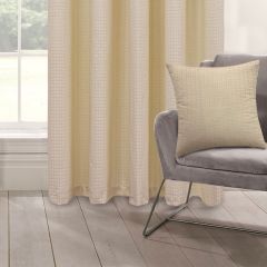 A gray modern chair with a Biscuit coloured cushion is set on light wood flooring. Beside it, beige curtains hang, creating a calm, minimalist ambiance.