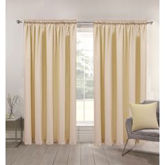 Cream-colored curtains hang from a rod, framing a window with a scenic view outside. A gray chair with a yellow cushion sits nearby, creating a calm, cozy ambiance.
