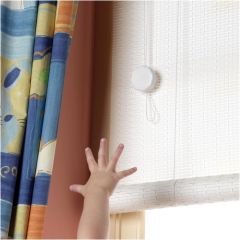 White blind cord shortener securing loose drawstring out of child’s reach