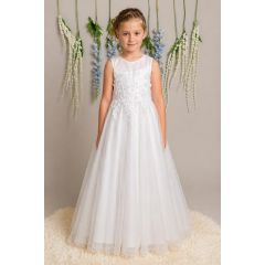 girl in white lace communion dress with full length skirt on neutral background