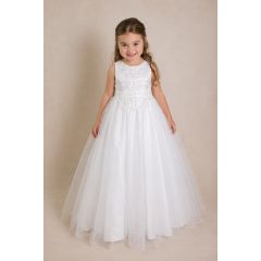 young girl wearing white embroidered communion dress with tulle skirt