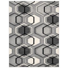 Face-on view of a grey geometric rug with interlocking hexagon patterns in shades of grey, black and cream on a white background