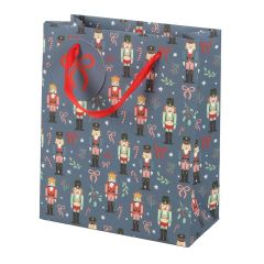 Blue Nutcracker Christmas gift bag decorated with toy soldier pattern and red ribbon handles