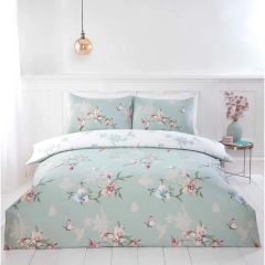 Duck egg blue floral duvet cover set with delicate pink flowers and butterfly print in a bright modern bedroom.

