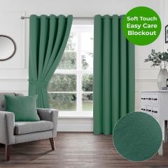 Forest green soft touch blockout eyelet curtains styled in a white living room