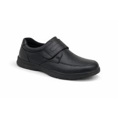 A black leather shoe with a wide Velcro strap, featuring a slightly rugged sole. The shoe is clean and simple, conveying a formal yet comfortable style.