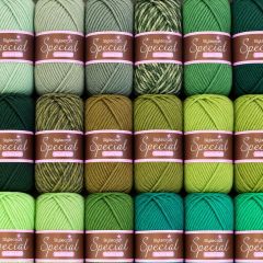 Rows of neatly arranged Stylecraft Special double-knit yarn skeins in mint, olive, lime, teal, and emerald green shades.