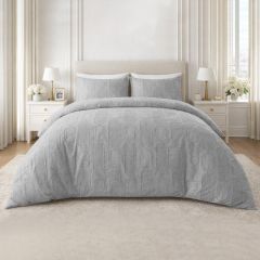 Grey embossed duvet cover set with a textured geometric design and matching pillowcases on a modern bed.