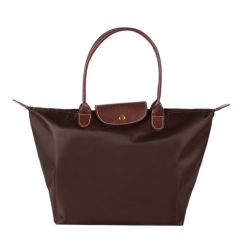 A black textured leather crossbody bag with a rounded rectangular shape. It features a prominent interlocking logo and a detachable strap with gold hardware.