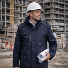 Navy waterproof jacket with a high collar, concealed front zip, pack-away hood, and multiple zip pockets on a white background.