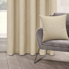 A gray modern chair with a Biscuit coloured cushion is set on light wood flooring. Beside it, beige curtains hang, creating a calm, minimalist ambiance.