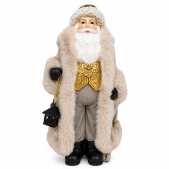 Elegant Santa Claus Christmas decoration dressed in a luxurious cream faux fur coat with gold waistcoat, carrying a black lantern and gift sack, perfect for festive home displays.
