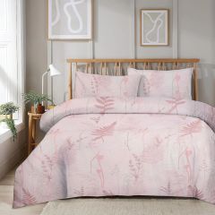 Quilted bedspread with red, pink, and blue floral patchwork design on a wooden bed, white walls, and abstract framed art.