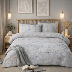 Cozy bedroom with a floral-patterned bedspread, wooden headboard, hanging pendant lights, candles, and framed abstract art on the wall.