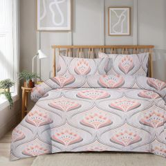 Bedroom with a wooden bed featuring a patterned comforter in pink and gray. Minimalist wall art and a small potted plant are visible.