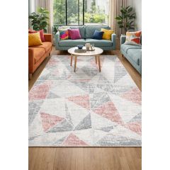 Modern living room with a geometric rug in soft Pink and grays. Features a teal sofa, orange couch, colorful cushions, wooden coffee table, and large window.