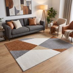Modern geometric living room rug in grey, rust, cream and beige with an abstract pattern.