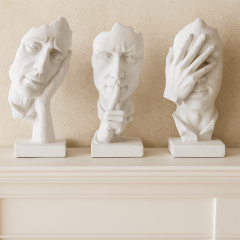 Modern white abstract face sculptures set of three on a mantel, contemporary resin home décor art pieces